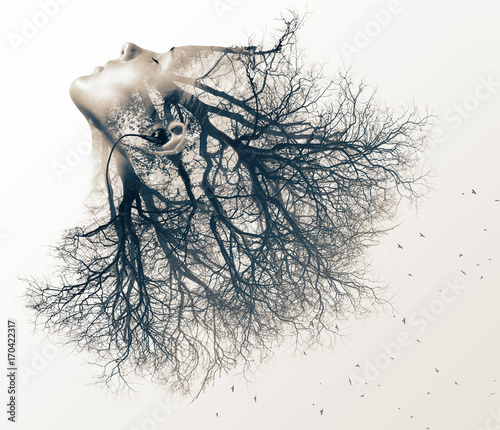 Double exposure portrait of young woman and tree. photo