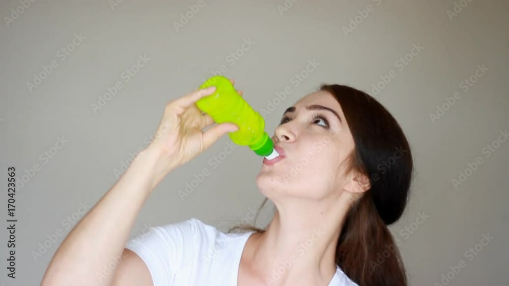 Happy young woman drinks Lemonade, juice, soda, kambuca. Drinking. Drink Happy young woman drinks Lemonade, juice, soda, kambuca. Drinking. Drink