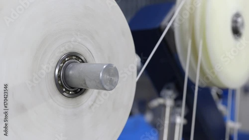 Production of cable products. Rollers a tension of a ready cable before winding on the coil.