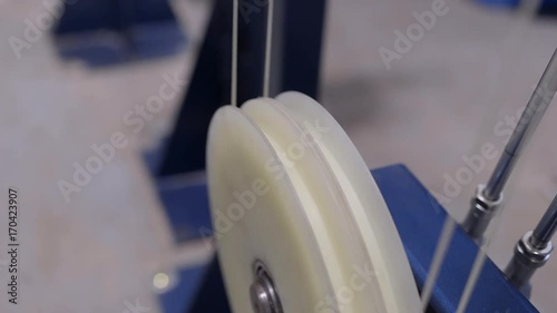 Production of cable products. Rollers a tension of a ready cable before winding on the coil.