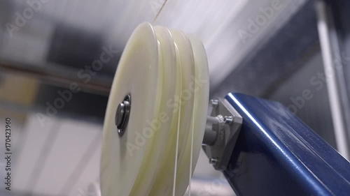 Production of cable products. Rollers a tension of a ready cable before winding on the coil.