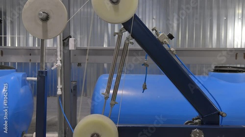 Production of cable products. Rollers a tension of a ready cable before winding on the coil.