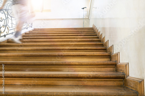 motion blur, man goes upstairs, old wooden stairs