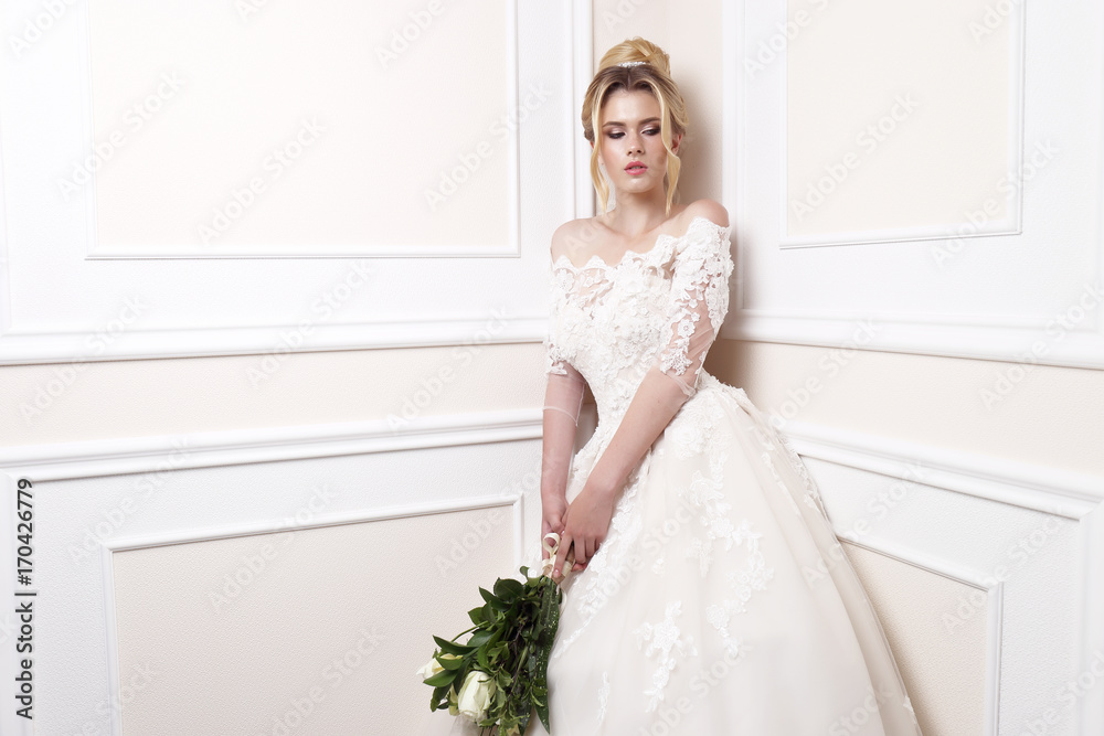 Young beautiful bride. Wedding hairstyle, blond hair, wedding dress, makeup and bride's bouquet. Young beautiful bride. Wedding hairstyle, blond hair, wedding dress, makeup and bride's bouquet.