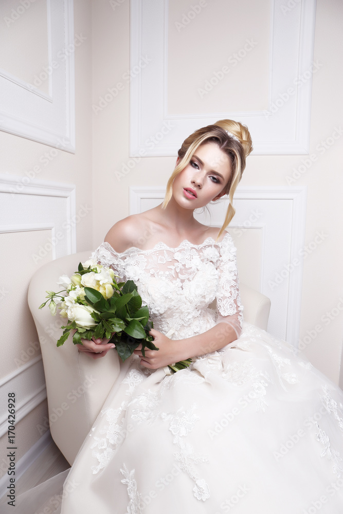 Young beautiful bride. Wedding hairstyle, blond hair, wedding dress, makeup and bride's bouquet. Young beautiful bride. Wedding hairstyle, blond hair, wedding dress, makeup and bride's bouquet.