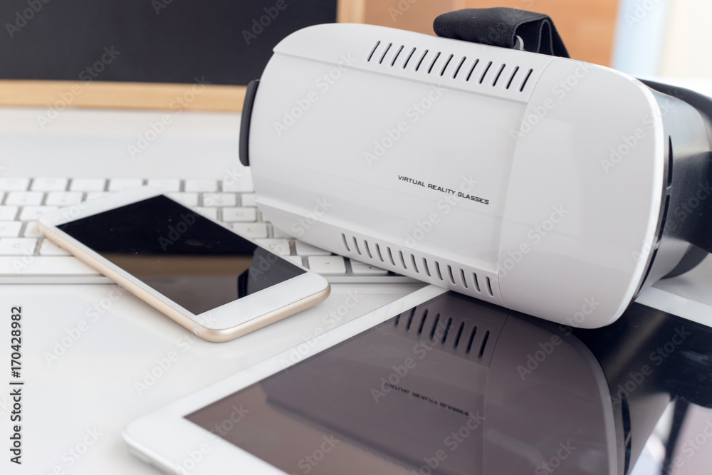 VIRTUAL REALITY GLASSES WITH TABLET AND SMART PHONE ON TABLE CONCEPT VIRTUAL REALITY GLASSES WITH TABLET AND SMART PHONE ON TABLE CONCEPT
