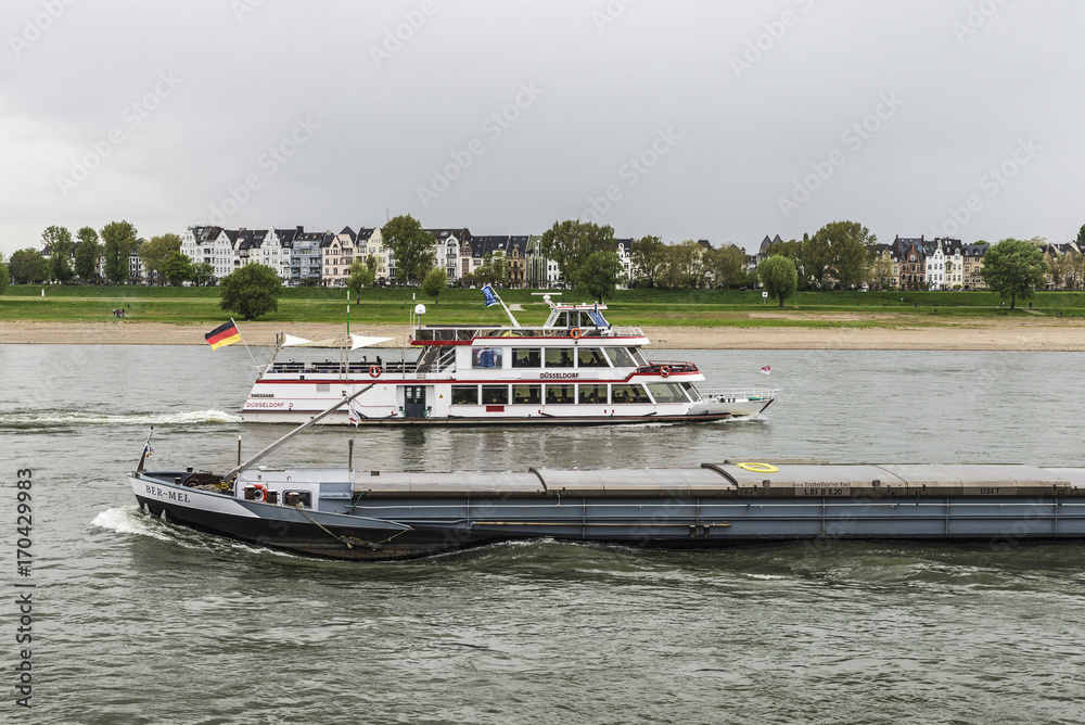 Merchant ship and cruise ship sailing on the Rhine River Merchant ship and cruise ship sailing on the Rhine River