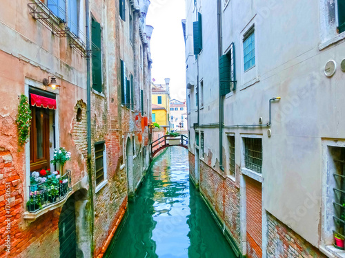 Classical picture of the venetian canals with boats across canal