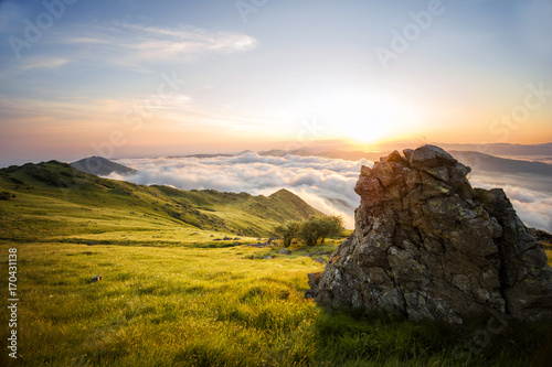 The Big Rock: A stunning view from above Mountains and Clouds while the Sun rises, Geopark del Beigua, UNESCO protected, Savona Province, Liguria, Italy, Europe photo