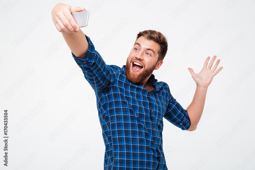 Happy bearded man in checkered shirt making selfie Happy bearded man in checkered shirt making selfie