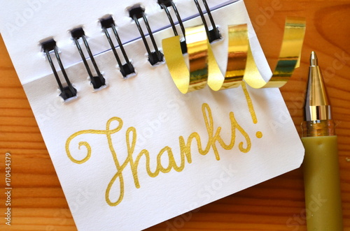 THANKS hand lettered on notepad with gold ribbon photo