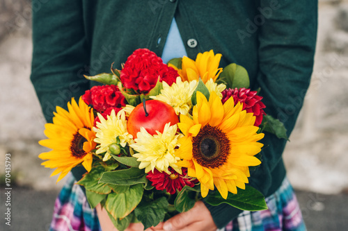 Fototapeta Naklejka Na Ścianę i Meble -  Beautiful bouquet of bright and colorful flowers holding by child's hands