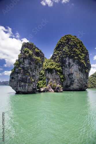 cruising among beautiful limestone rocks and secluded beaches in Ha Long bay, UNESCO world heritage site, Vietnam