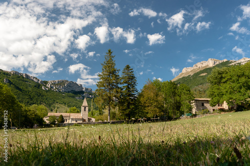 Old authentic french village with church overlooking the plain photo