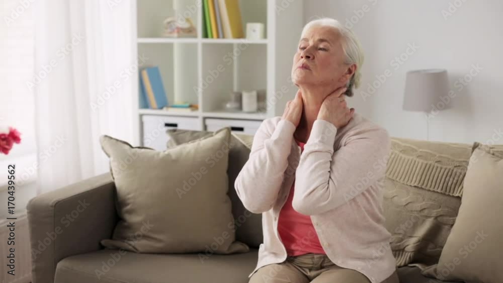 senior woman suffering from neck pain at home senior woman suffering from neck pain at home