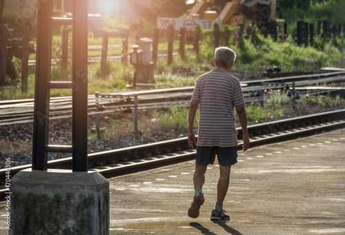 Older men are walking exercise for health in the evening. subject is blurred.