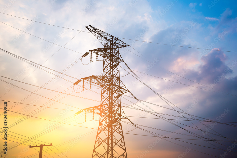 Impression network at transformer station in sunrise, high voltage up to yellow sky take with yellow tone, horizontal frame