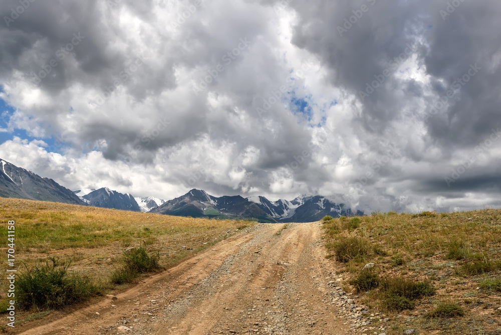 road mountain steppe overcast sky