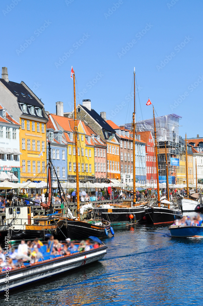 Nyhavn district is one of the most famous and beautiful landmark in Copenhagen, Denmark in a sunny day
