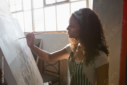 Woman painting on canvas photo