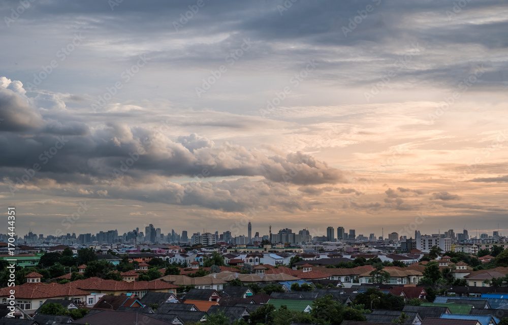 Sunset with cloudy sky over the city