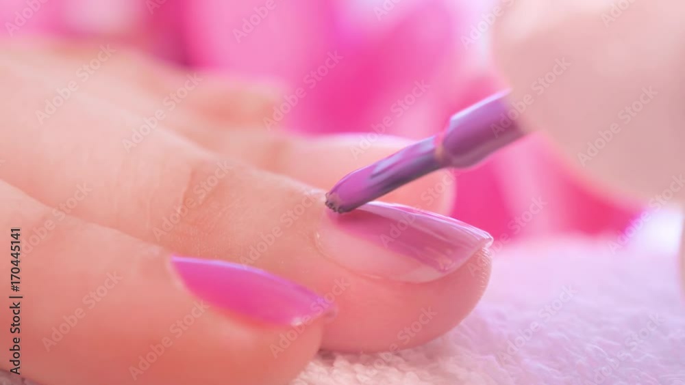 Female hands manicure close up view. Delicate purple manicure