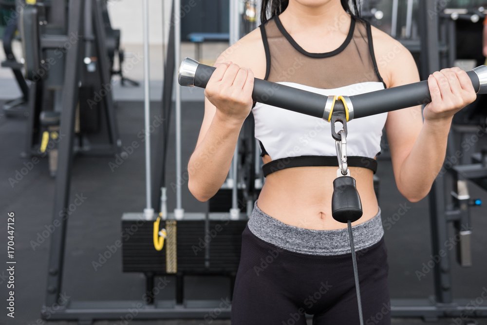 young woman execute exercise with machine in fitness center. female athlete pump up muscle with cable crossover in gym. sporty girl working out in health club. young woman execute exercise with machine in fitness center. female athlete pump up muscle with cable crossover in gym. sporty girl working out in health club.