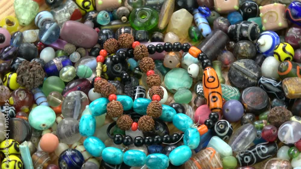 Rotating colorful various indian old and new beads bracelet background Rotating colorful various indian old and new beads bracelet background