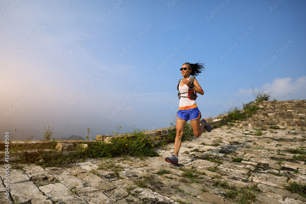 running woman trail runner on the great wall top of mountain running woman trail runner on the great wall top of mountain