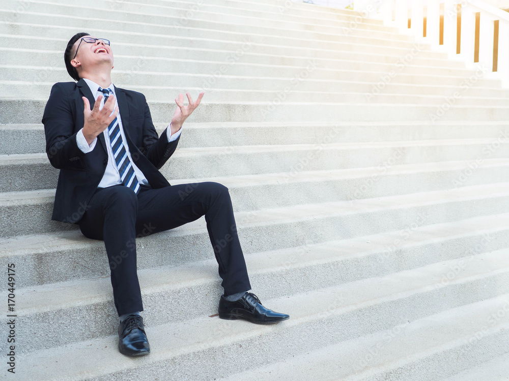 Angry strain happy businessman is sitting on the stairs Angry strain happy businessman is sitting on the stairs
