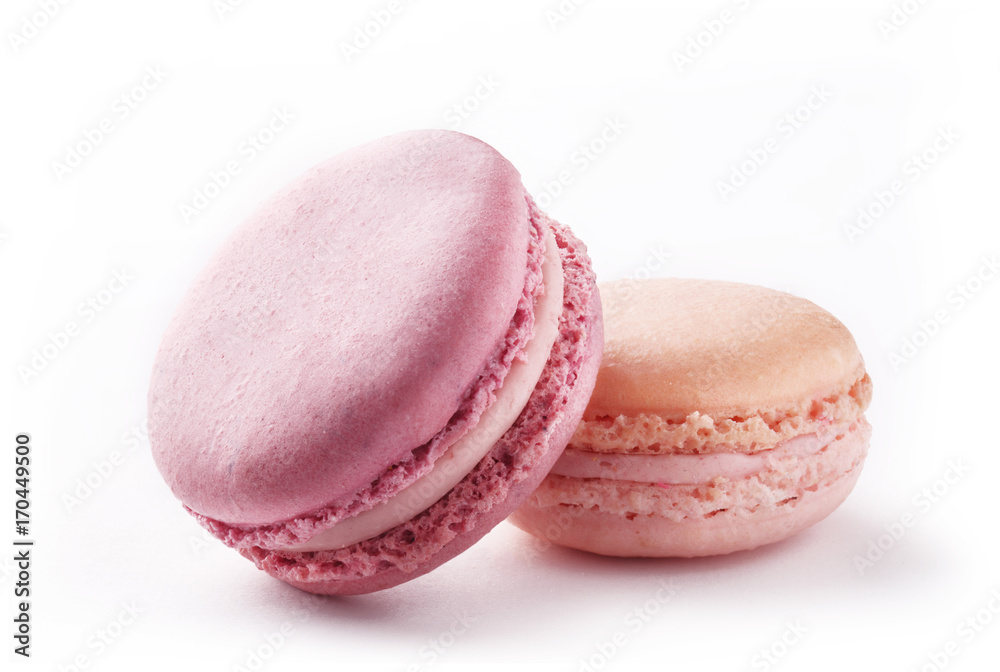 Colorful macarons on a white background. French sweets couple on white paper Colorful macarons on a white background. French sweets couple on white paper