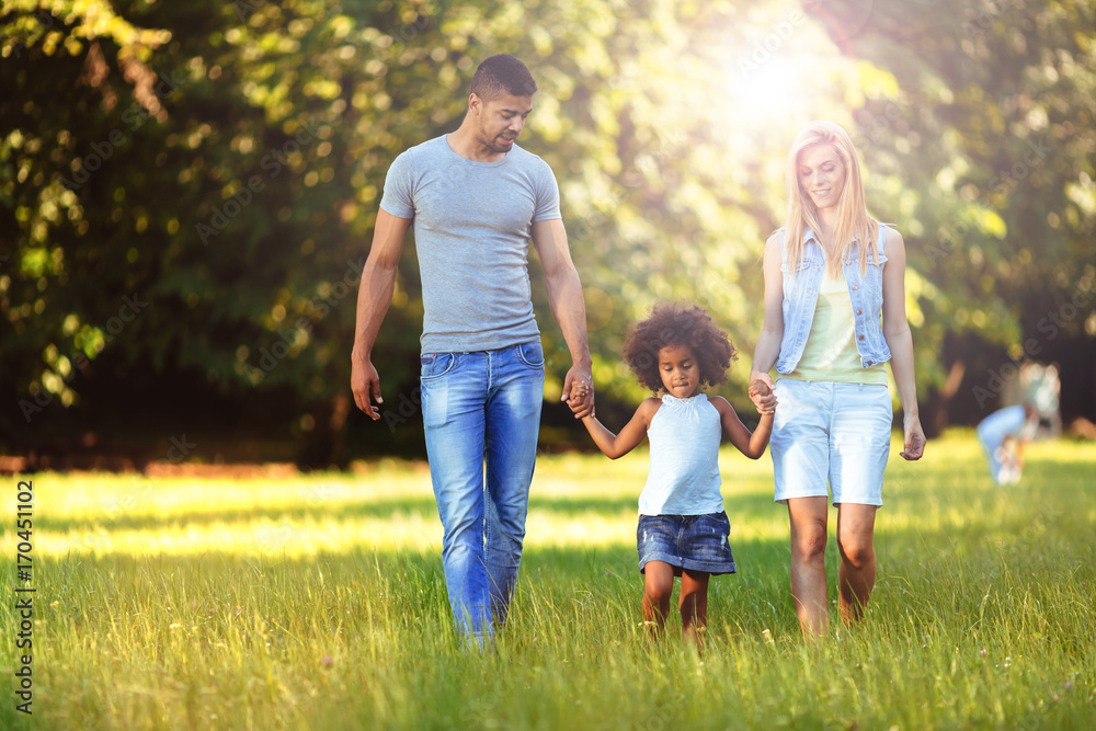 Happy young couple spending time with their daughter