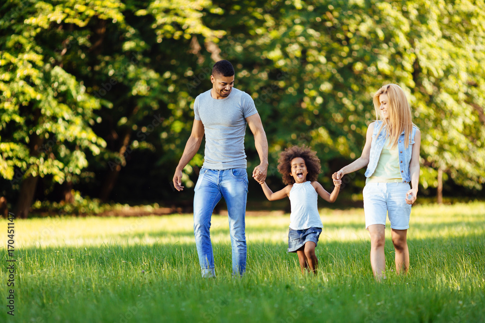 Happy young couple spending time with their daughter