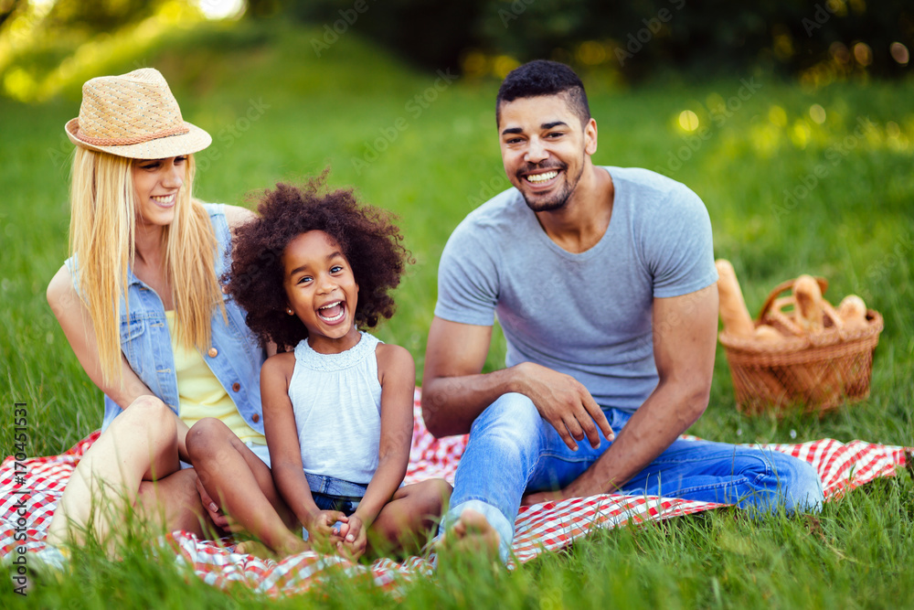 Picture of lovely couple with their daughter having picnic Picture of lovely couple with their daughter having picnic