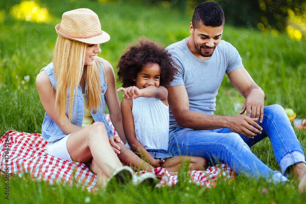 Picture of lovely couple with their daughter having picnic Picture of lovely couple with their daughter having picnic