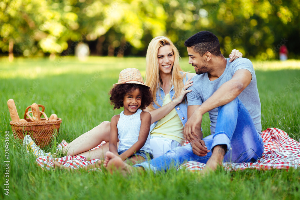 Picture of lovely couple with their daughter having picnic Picture of lovely couple with their daughter having picnic