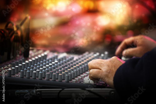 Working sound control panel or mixing console in front of the stage at a music festival concert