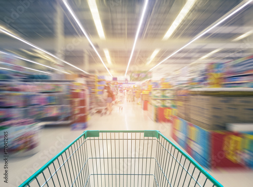 Supermarket store abstract blur background with shopping cart, Supermarket aisle with empty shopping cart