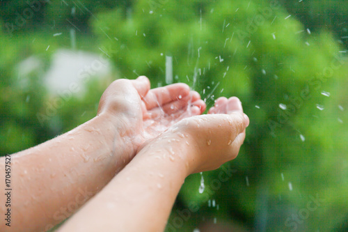 Female hands in the rain