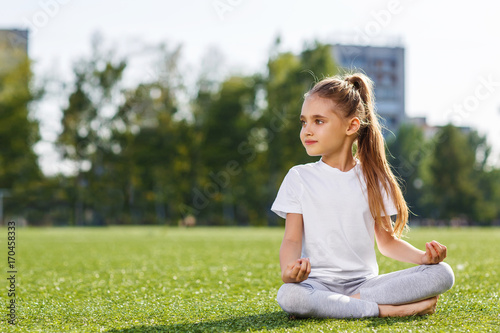 Little girl doing fitness outdoor