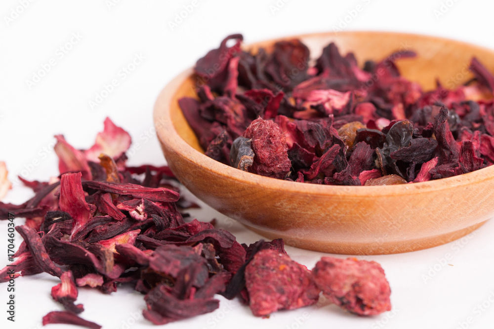 Dry tea in wooden plates, on white background. Leaves of red, green and black tea. Macro photo. Dry tea in wooden plates, on white background. Leaves of red, green and black tea. Macro photo.