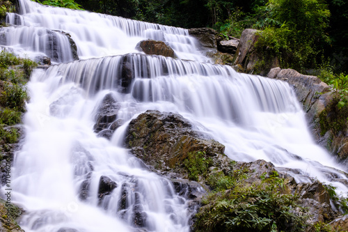 Closeup smooth flow water from Mae Phun waterfalls in Laplae District, Uttaradit province of Thailand