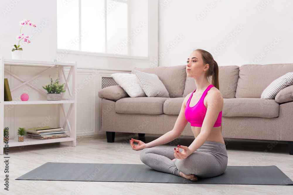 Woman training yoga in lotus pose Woman training yoga in lotus pose