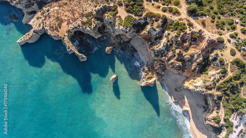 Aerial. Rocky shore formation and beaches of Portimao. View from sky.