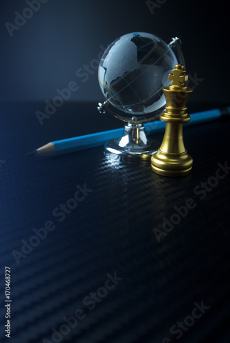 global world glass and chess game on black ground