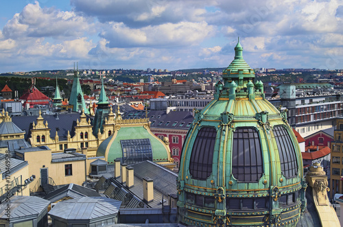 Amazing view of the roofs of buildings in Prague from the Powder tower at sunny day. Art Nouveau style dome of the Municipal House. Prague, Czech Republic 