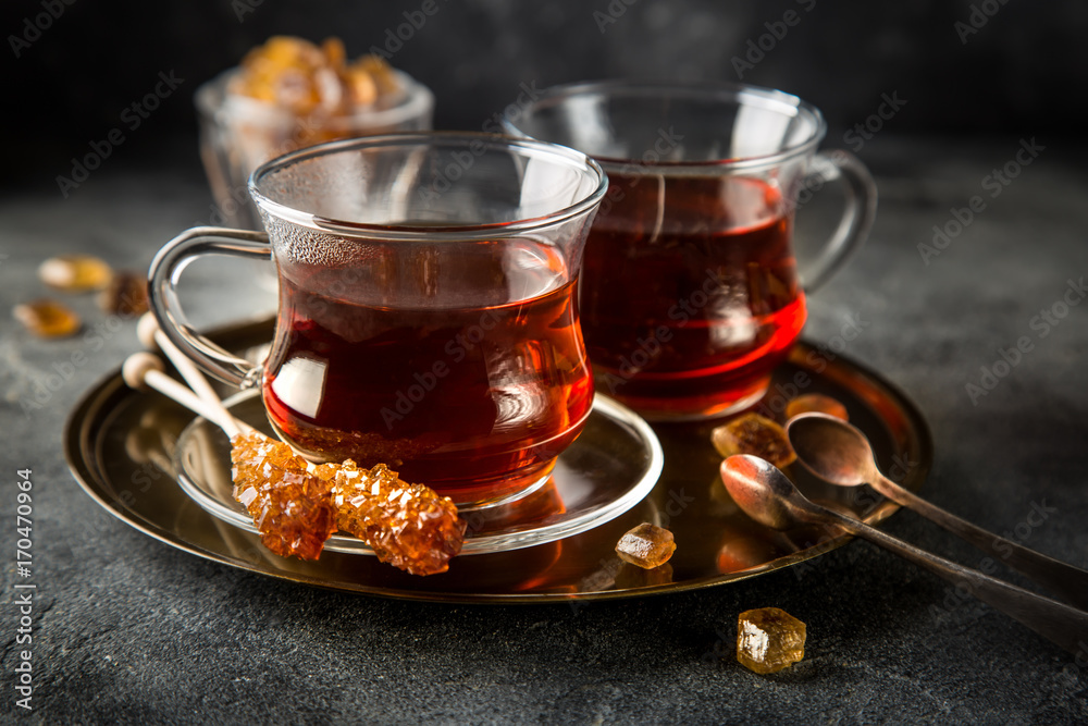 tea in glass cup with caramelized sugar tea in glass cup with caramelized sugar