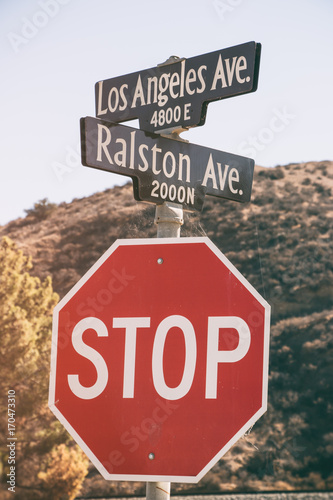Street signs for Los Angeles Avenue and Ralston Avenue and stop sign in Simi Valley, California. photo