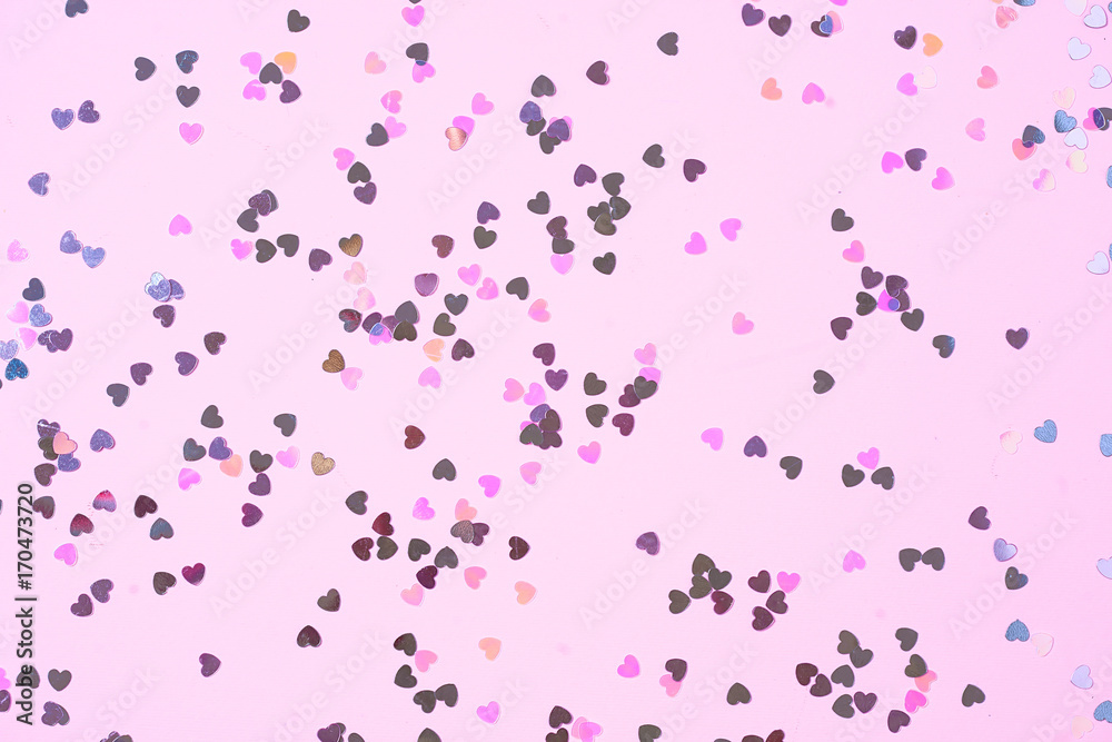 Pink background with heart shaped confetti. Festive and holiday. St. Valentine's day concept. top view, flat lay