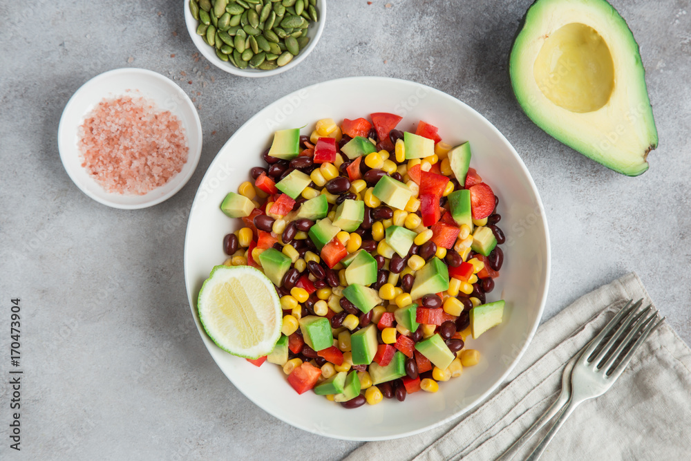Avocado, black bean, corn and bell pepper salad in white bowl Avocado, black bean, corn and bell pepper salad in white bowl